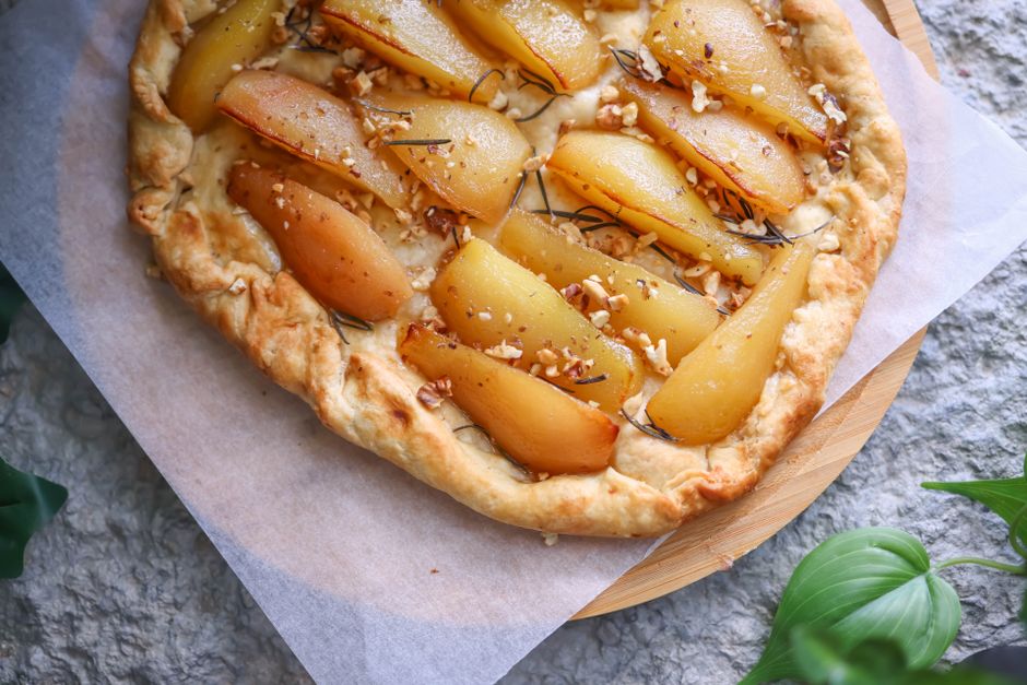 Part de tarte Bourdaloue aux poires et amandes sur table rustique